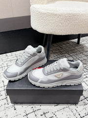 PRADA 25S MEN SNEAKERS IN GRAY AND WHITE CANVAS
