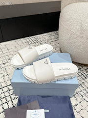 PRADA 25S PADDED SLIDES IN WHITE CALFSKIN WITH LOGO
