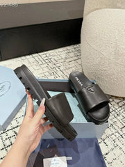 PRADA 25S PADDED SLIDES IN BLACK CALFSKIN WITH LOGO