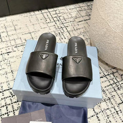 PRADA 25S PADDED SLIDES IN BLACK CALFSKIN WITH LOGO