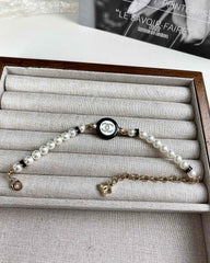 Classic CC bracelet with faux pearls and black resin.