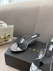 ALAIA HEELED THONG 25S 55 MM IN WHITE AND BLACK LAMBSKIN SNAKE-EMBOSSED WITH CLEAR STRAP