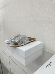 ALAIA VIENNE FLAT MULES IN SILVER LAMBSKIN