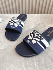 DIOR FLAT SLIDES 25S IN MIDNIGHT BLUE CALFSKIN AND FABRIC EMBROIDERED BUTTERFLY MOTIF