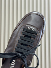 PRADA 25S COLLAPSE MULES IN DARK BROWN CALFSKIN