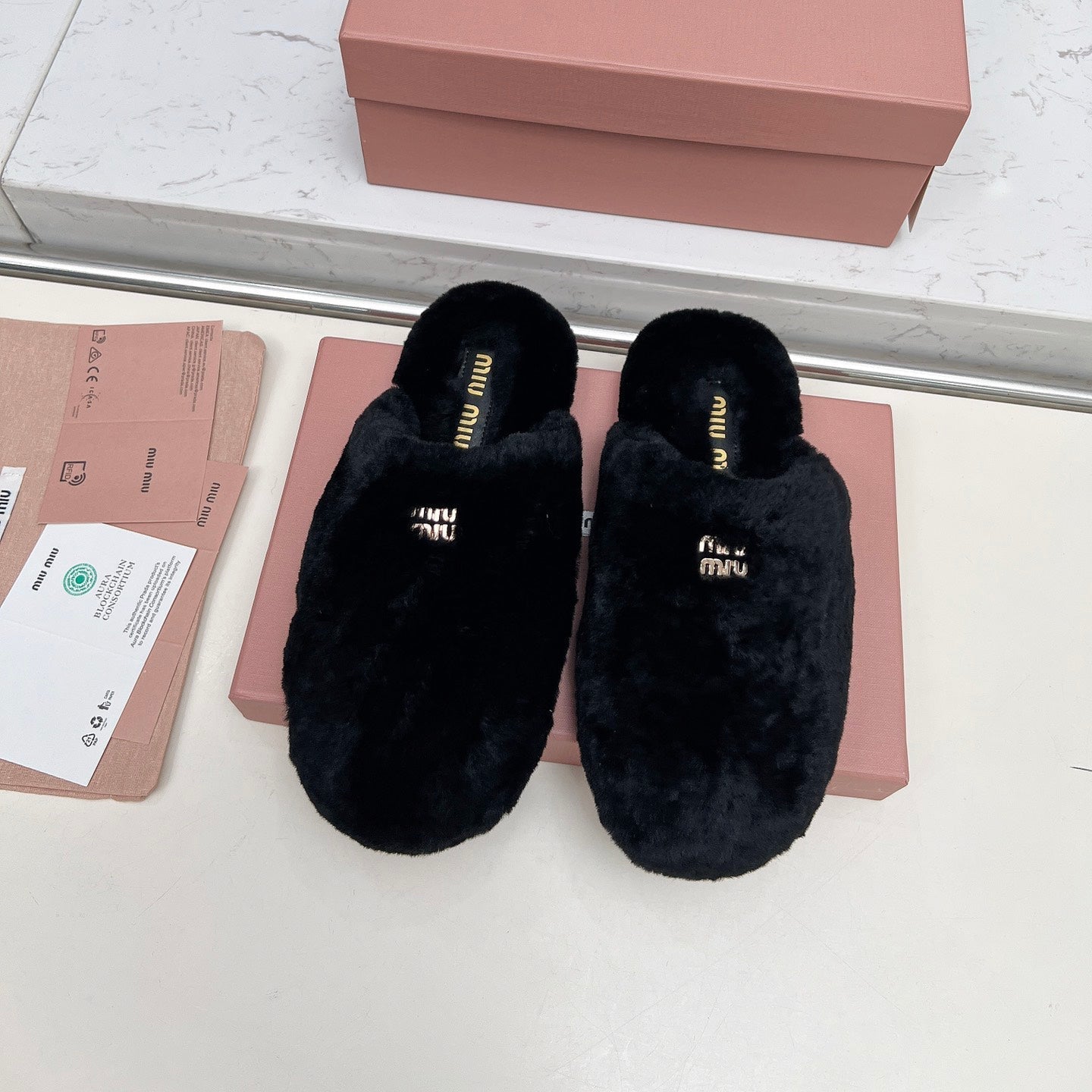 MIUMIU 26S MULES IN BLACK SHEARLING