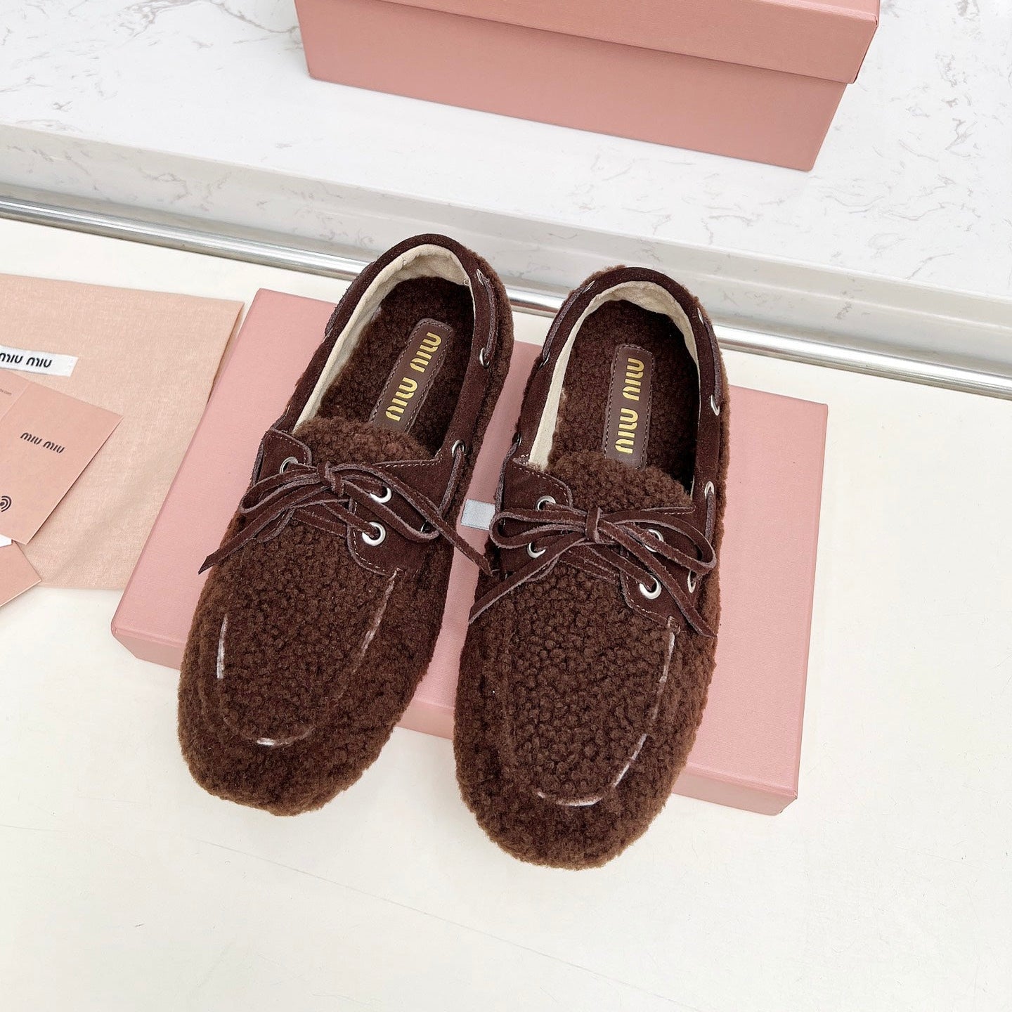 MIUMIU 26S BOAT LOAFERS IN DARK BROWN SHEARLING