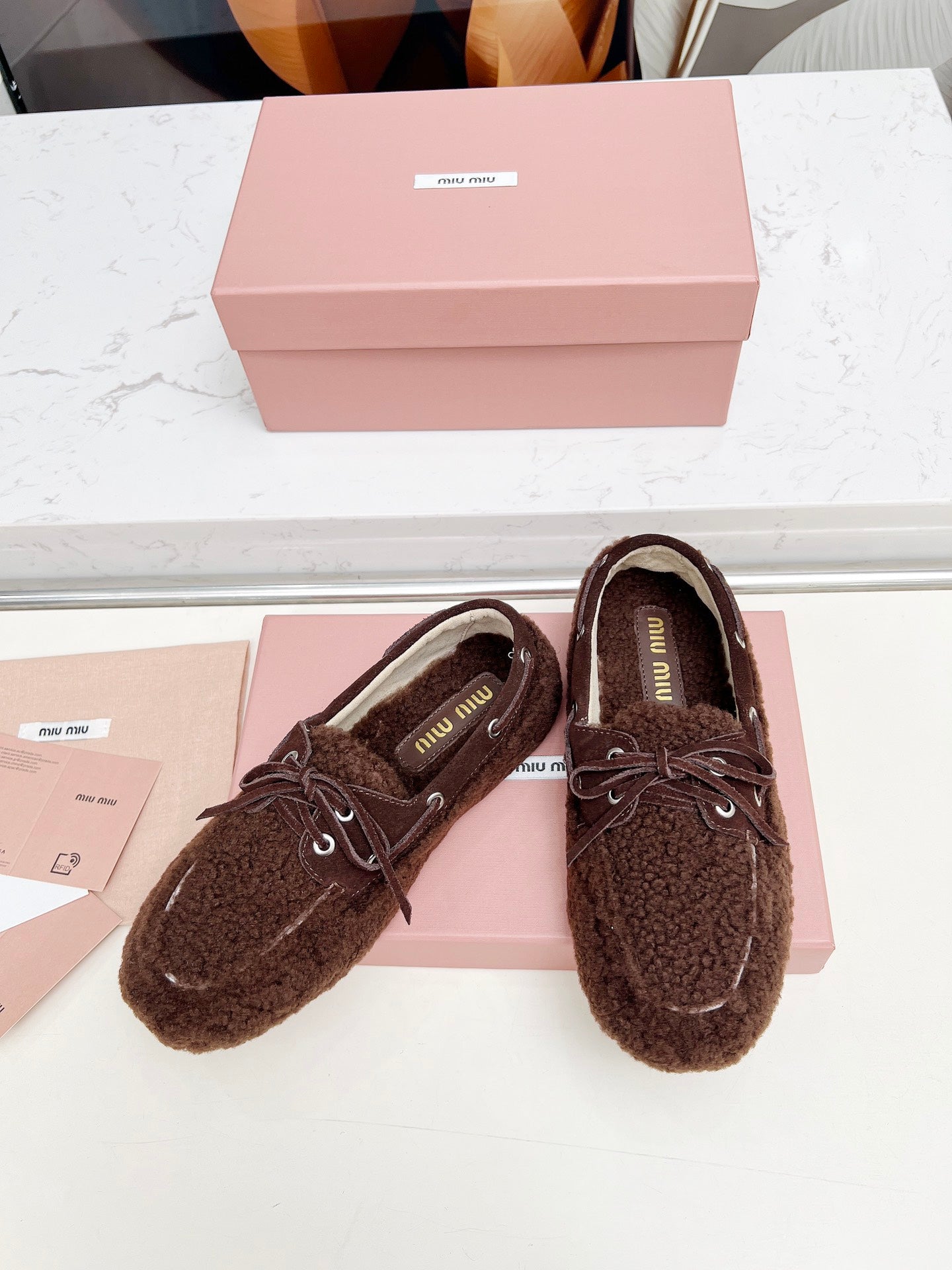 MIUMIU 26S BOAT LOAFERS IN DARK BROWN SHEARLING