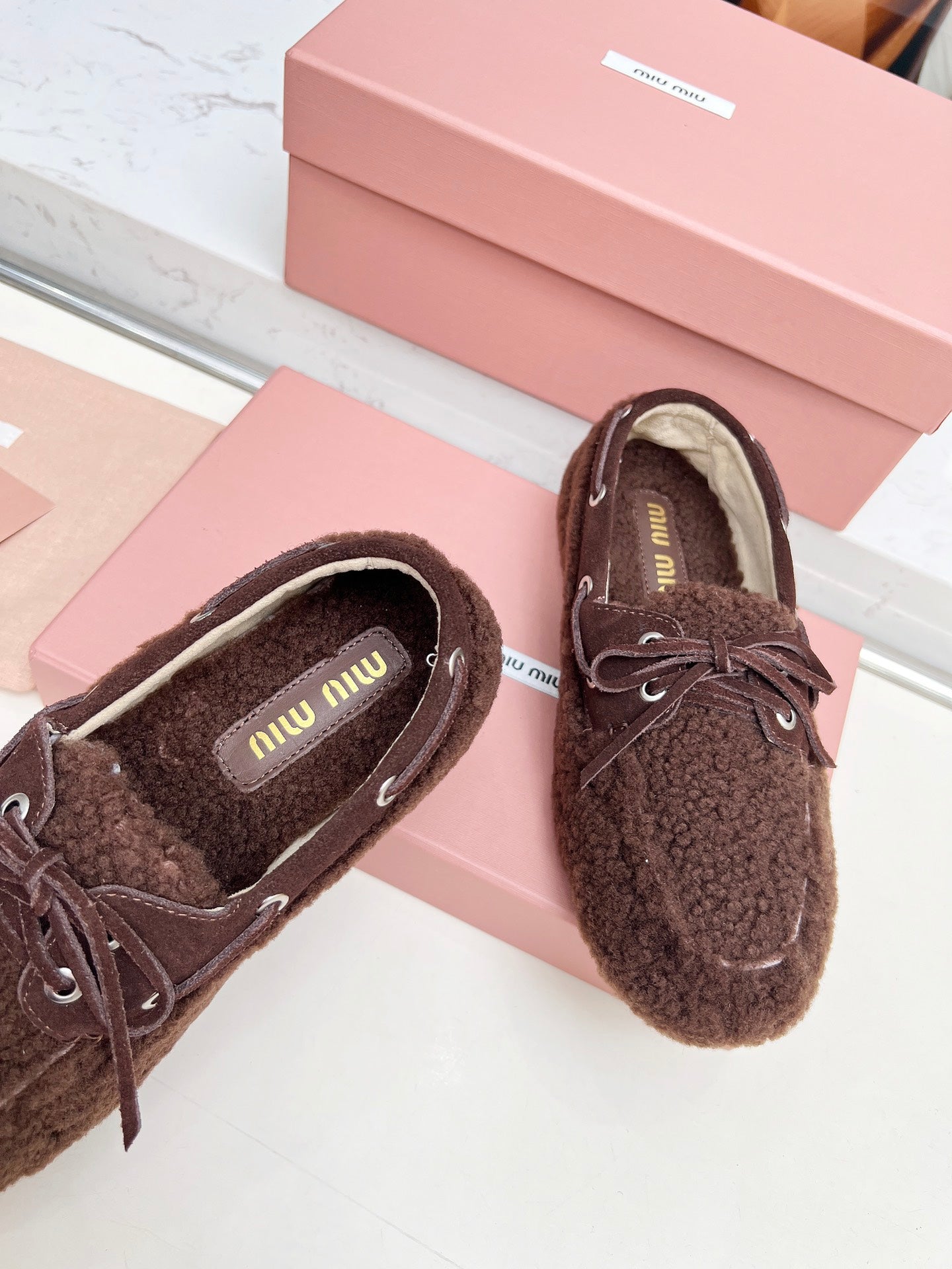 MIUMIU 26S BOAT LOAFERS IN DARK BROWN SHEARLING