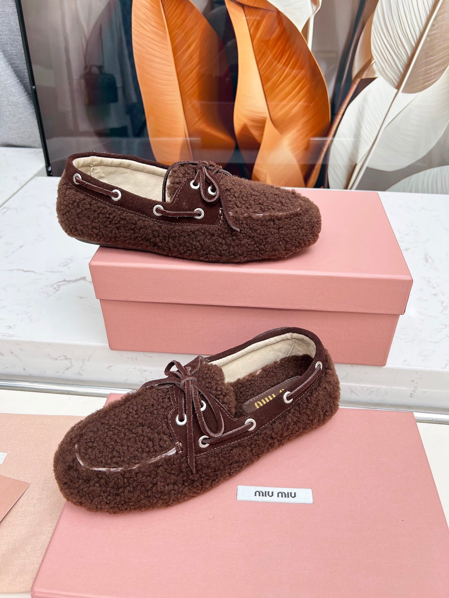 MIUMIU 26S BOAT LOAFERS IN DARK BROWN SHEARLING