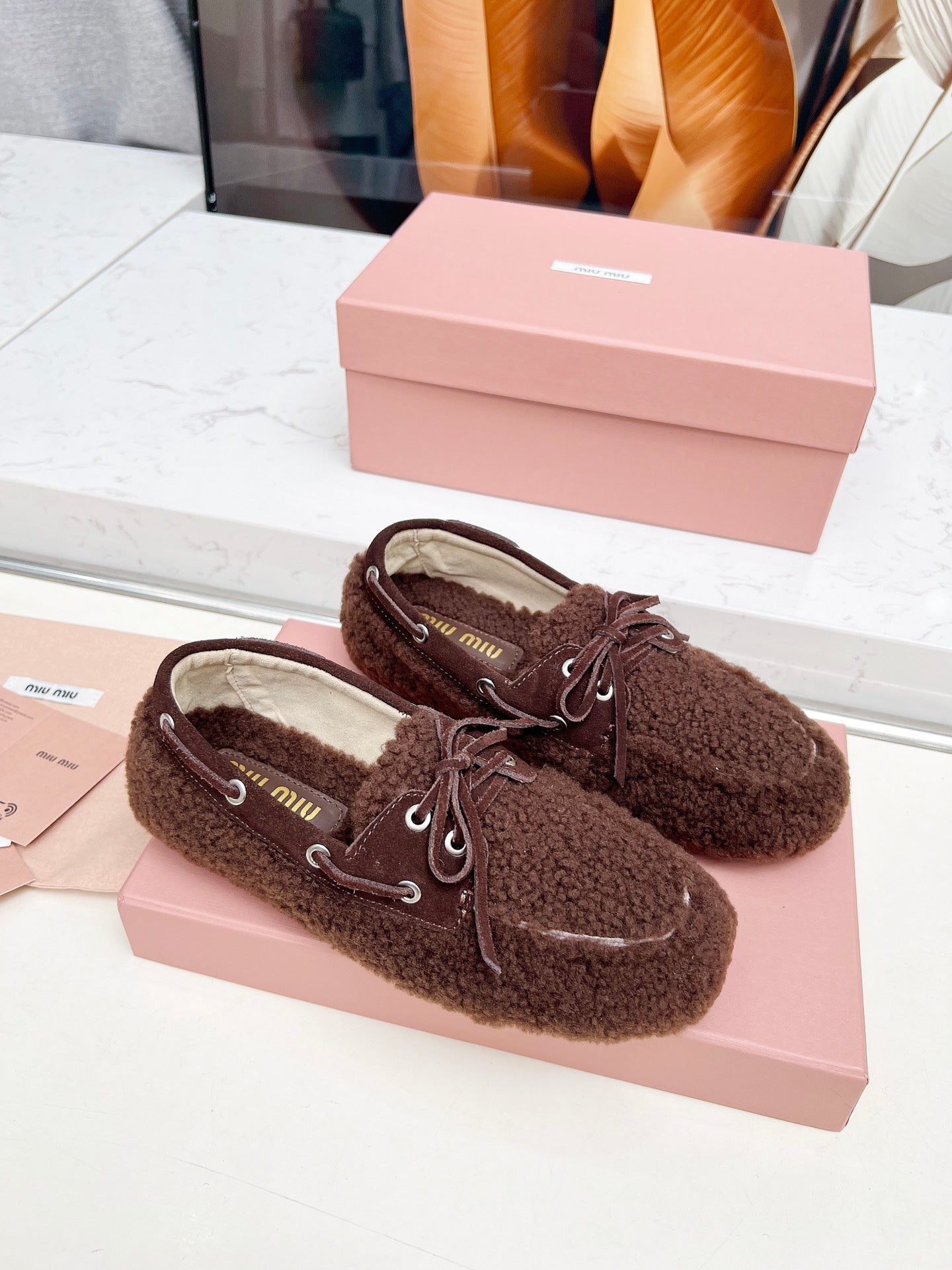 MIUMIU 26S BOAT LOAFERS IN DARK BROWN SHEARLING