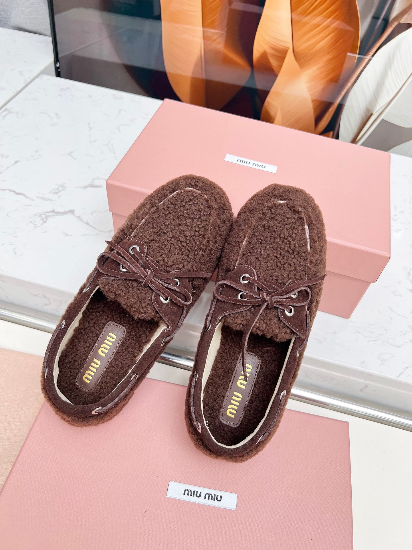 MIUMIU 26S BOAT LOAFERS IN DARK BROWN SHEARLING
