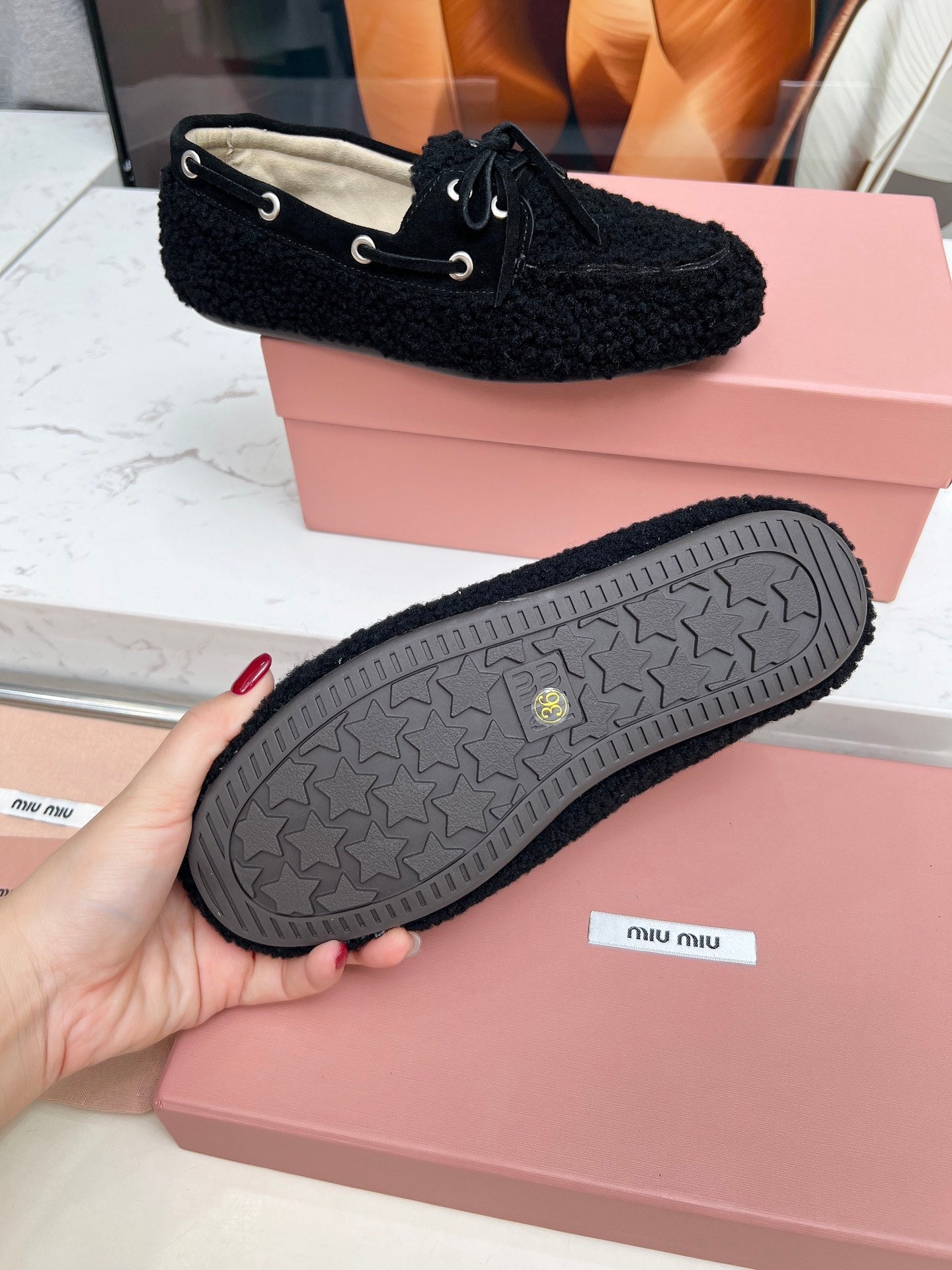 MIUMIU 26S BOAT LOAFERS IN BLACK SHEARLING