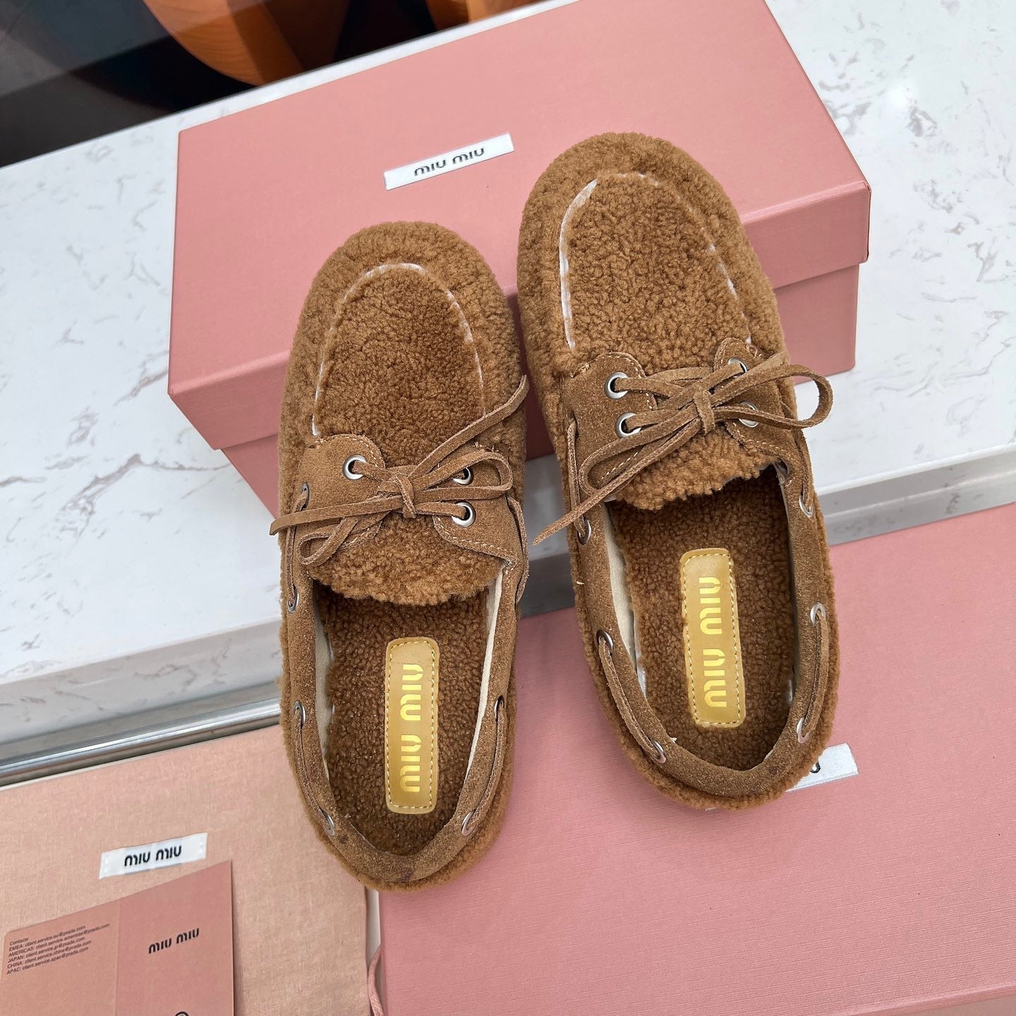 MIUMIU 26S BOAT LOAFERS IN BROWN SHEARLING