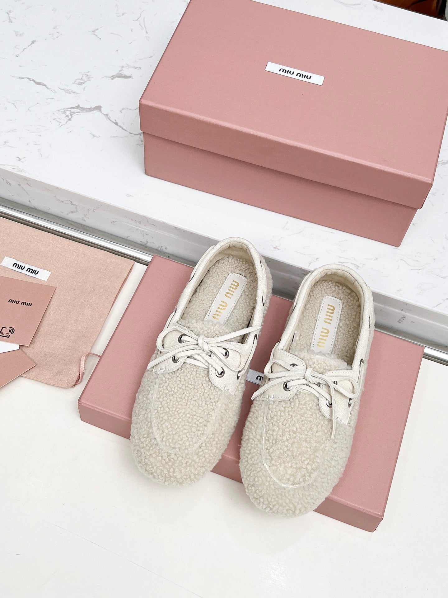 MIUMIU 26S BOAT LOAFERS IN BEIGE SHEARLING
