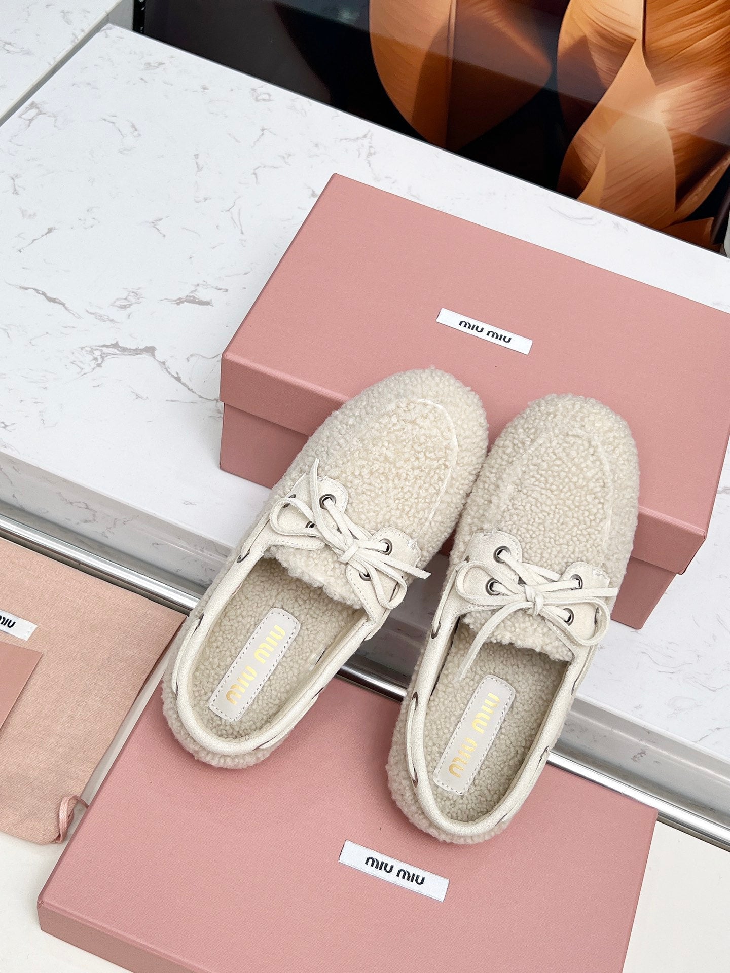 MIUMIU 26S BOAT LOAFERS IN BEIGE SHEARLING