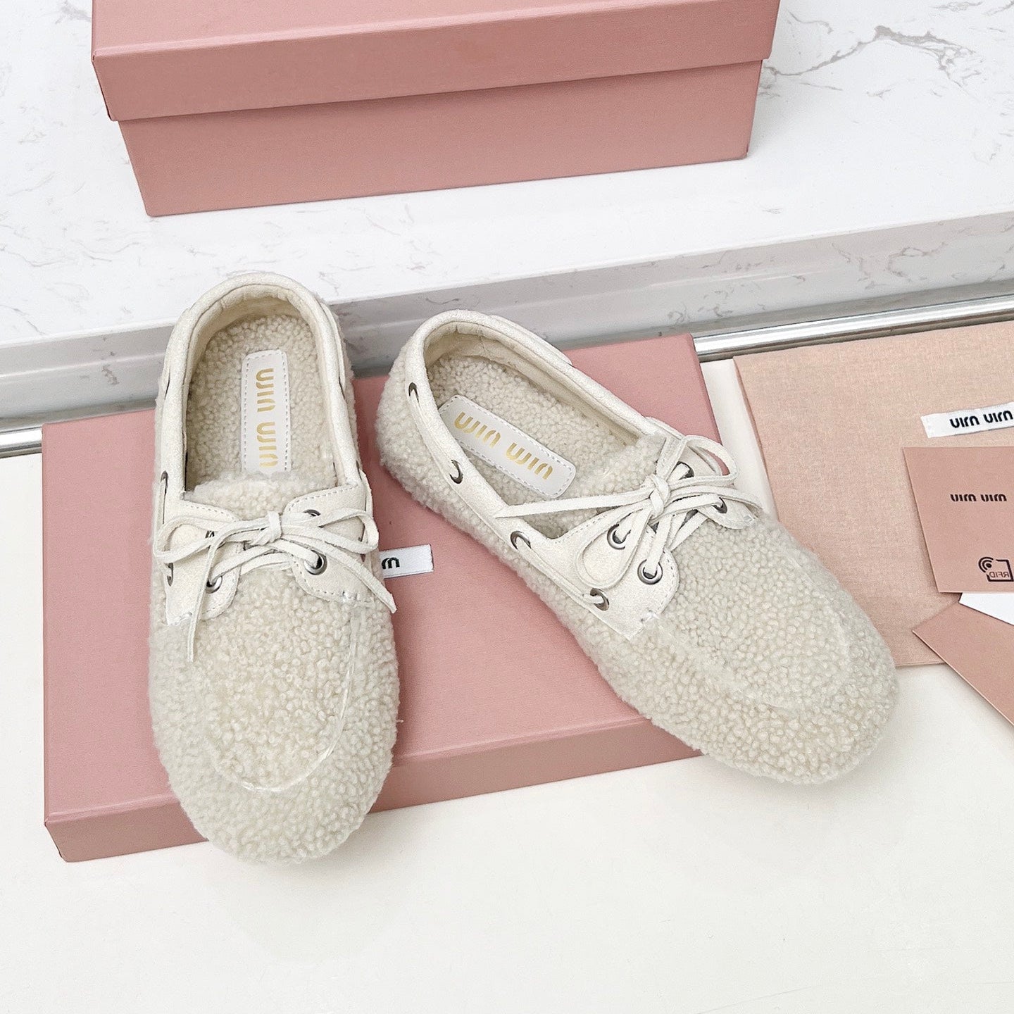 MIUMIU 26S BOAT LOAFERS IN BEIGE SHEARLING