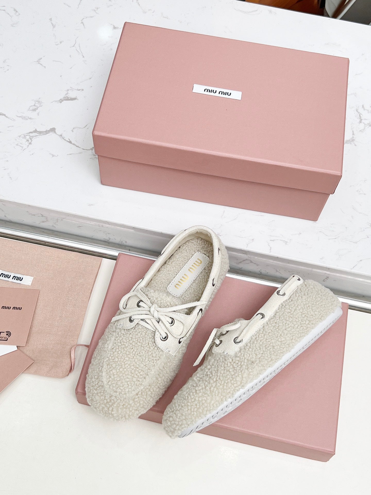 MIUMIU 26S BOAT LOAFERS IN BEIGE SHEARLING
