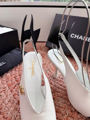 CHANEL 26S POINTED TOE HIGH HEEL SLINGBACKS IN WHITE LAMBSKIN WITH BLACK FLORAL APPLIQUE