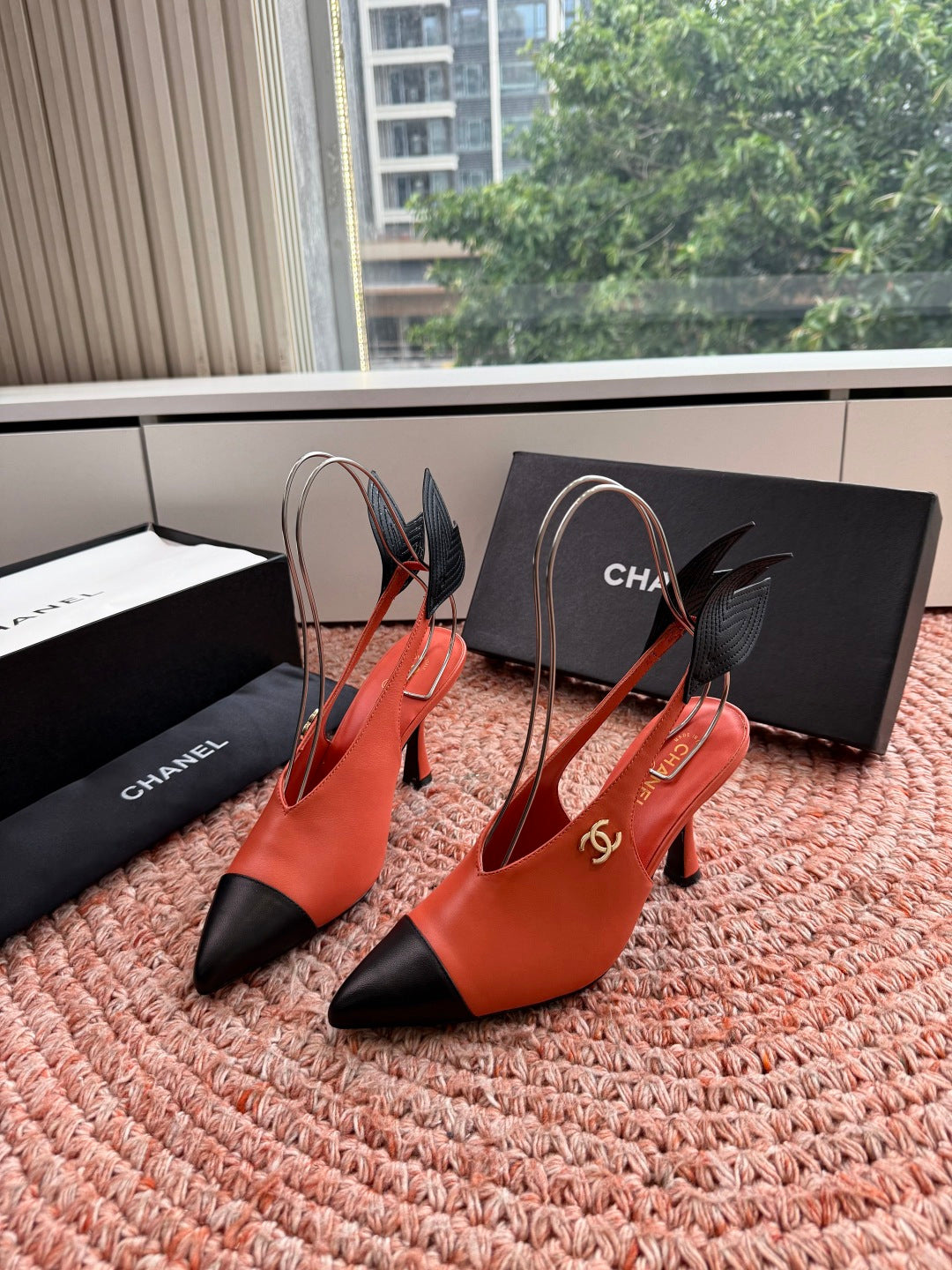 CHANEL 26S POINTED TOE HIGH HEEL SLINGBACKS IN ORANGE LAMBSKIN WITH BLACK FLORAL APPLIQUE
