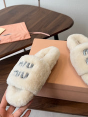 MIUMIU 26S CRYSTAL LOGO SLIDES IN LIGHT BEIGE SHEARLING