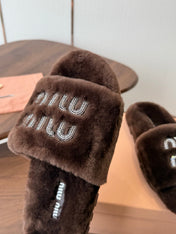 MIUMIU 26S CRYSTAL LOGO SLIDES IN DARK BROWN SHEARLING