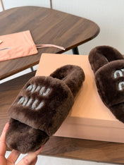 MIUMIU 26S CRYSTAL LOGO SLIDES IN DARK BROWN SHEARLING