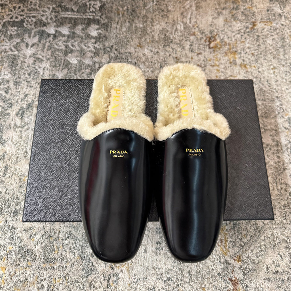 PRADA 25S CLOGS IN BLACK CALFSKIN AND BEIGE FUR-LINED