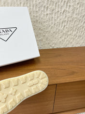 PRADA 25S PLATFORM FUR-LINED MULES IN EARTH BROWN SUEDE