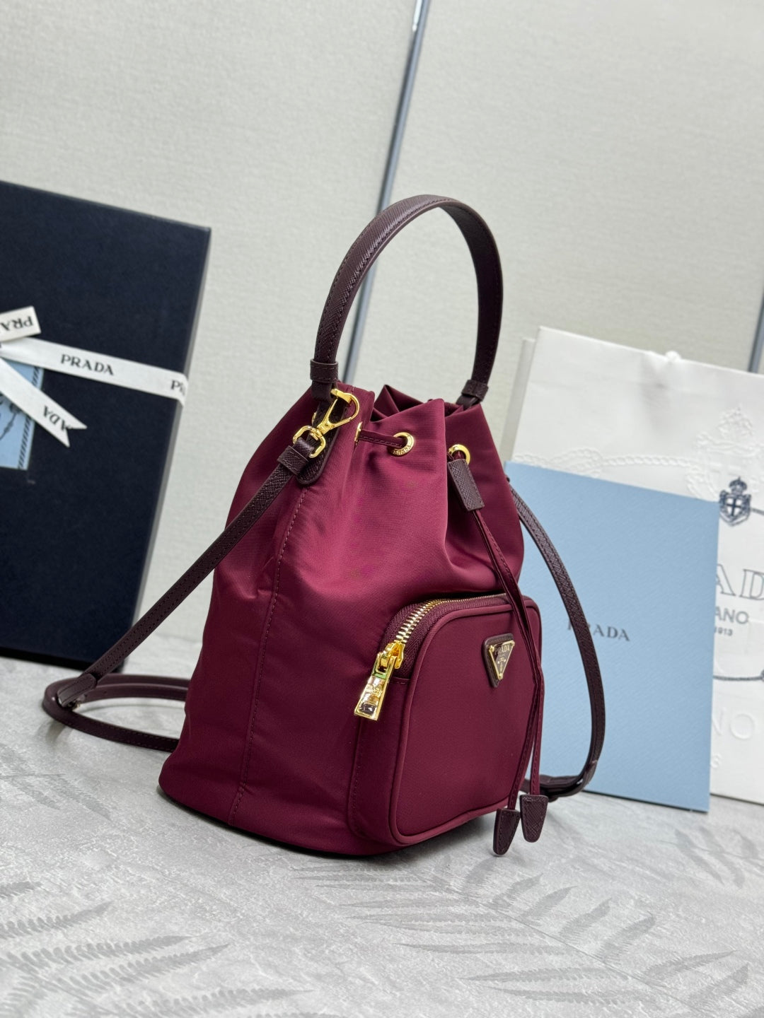 PRADA 25S DUET BUCKET BAG 23 IN BURGUNDY RE-NYLON GOLD HARDWARE