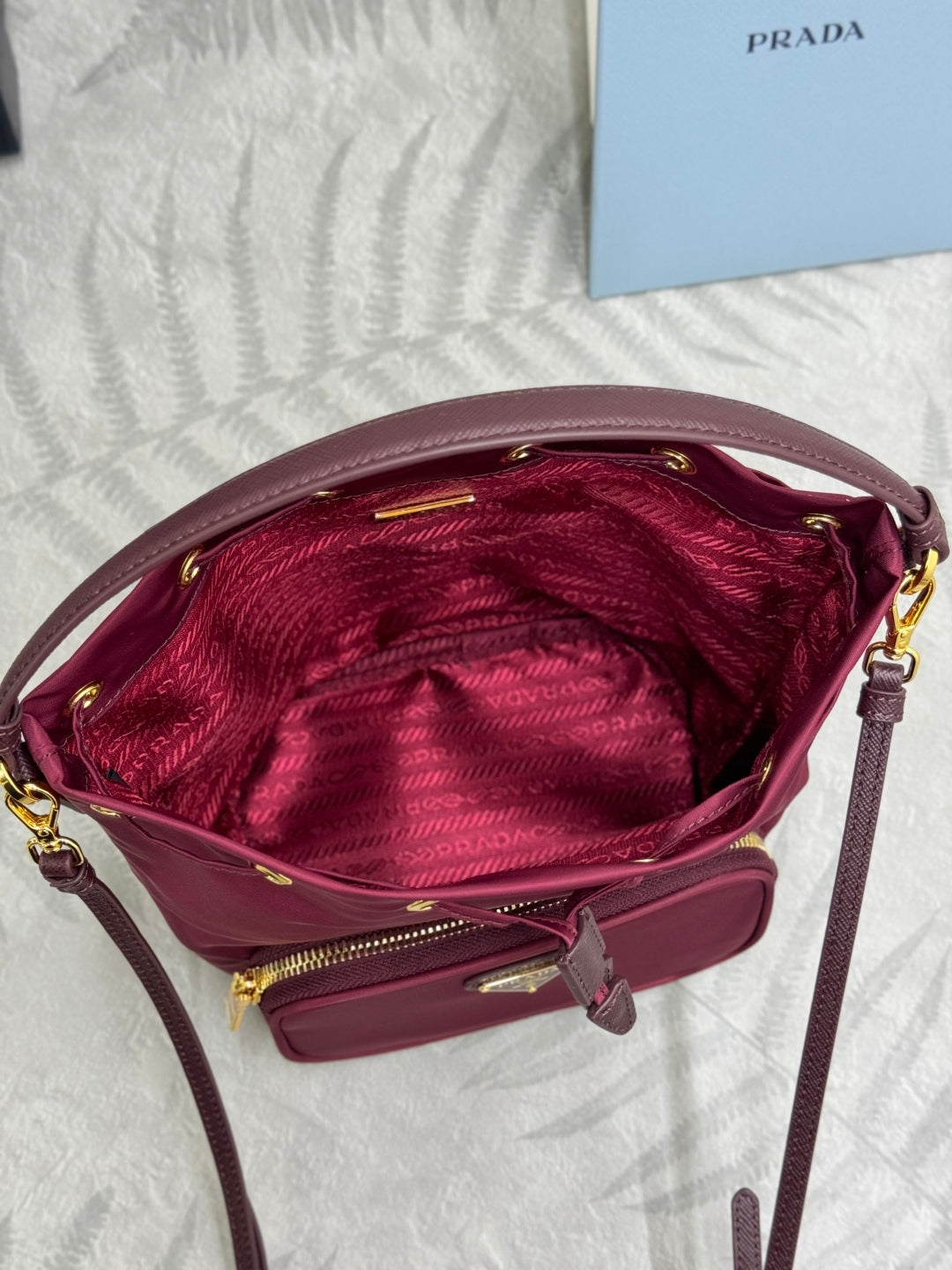 PRADA 25S DUET BUCKET BAG 23 IN BURGUNDY RE-NYLON GOLD HARDWRE