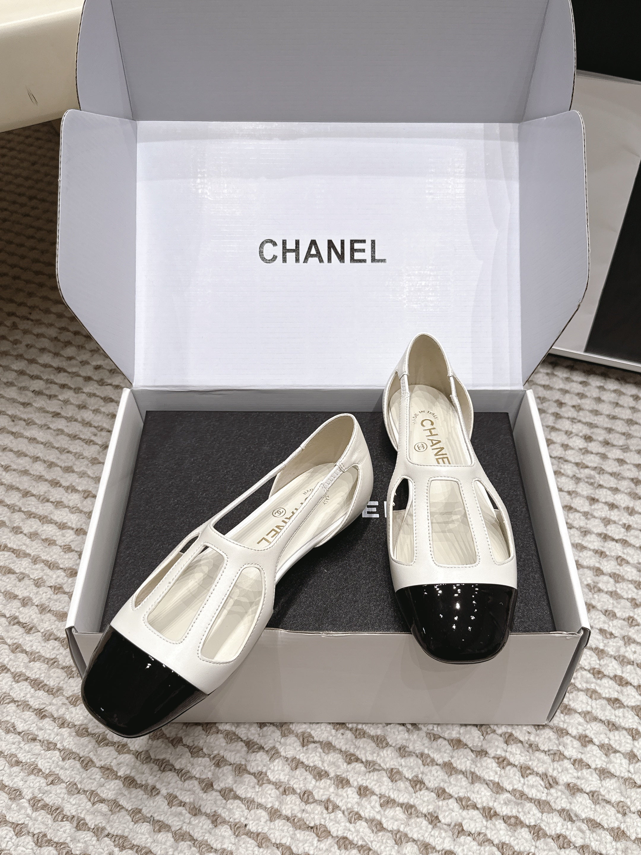 CHANEL 26S ROUND TOE MARY JANE FLATS IN OFF WHITE CUTOUT CALFSKIN WITH BLACK PATENT TOE