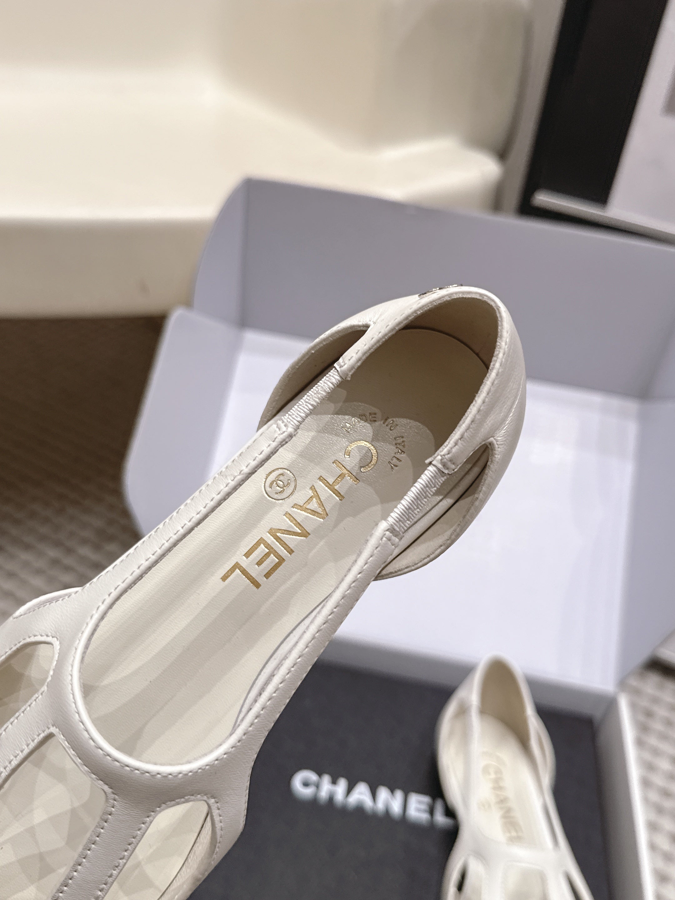 CHANEL 26S ROUND TOE MARY JANE FLATS IN OFF WHITE CUTOUT CALFSKIN WITH BLACK PATENT TOE
