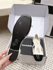 CHANEL 26S ROUND TOE MARY JANE FLATS IN OFF WHITE CUTOUT CALFSKIN WITH BLACK PATENT TOE