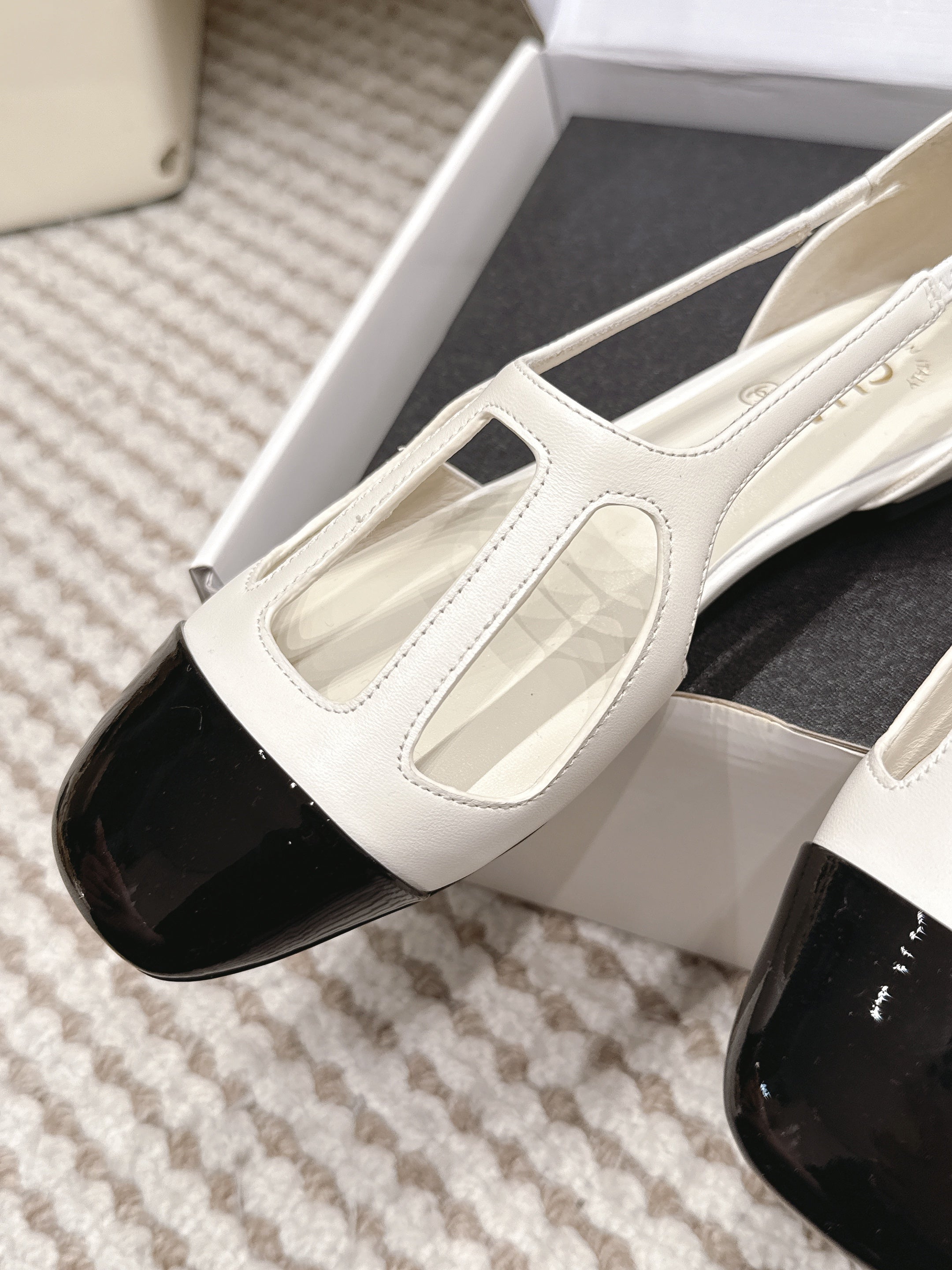 CHANEL 26S ROUND TOE MARY JANE FLATS IN OFF WHITE CUTOUT CALFSKIN WITH BLACK PATENT TOE