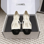 CHANEL 26S ROUND TOE MARY JANE FLATS IN OFF WHITE CUTOUT CALFSKIN WITH BLACK PATENT TOE