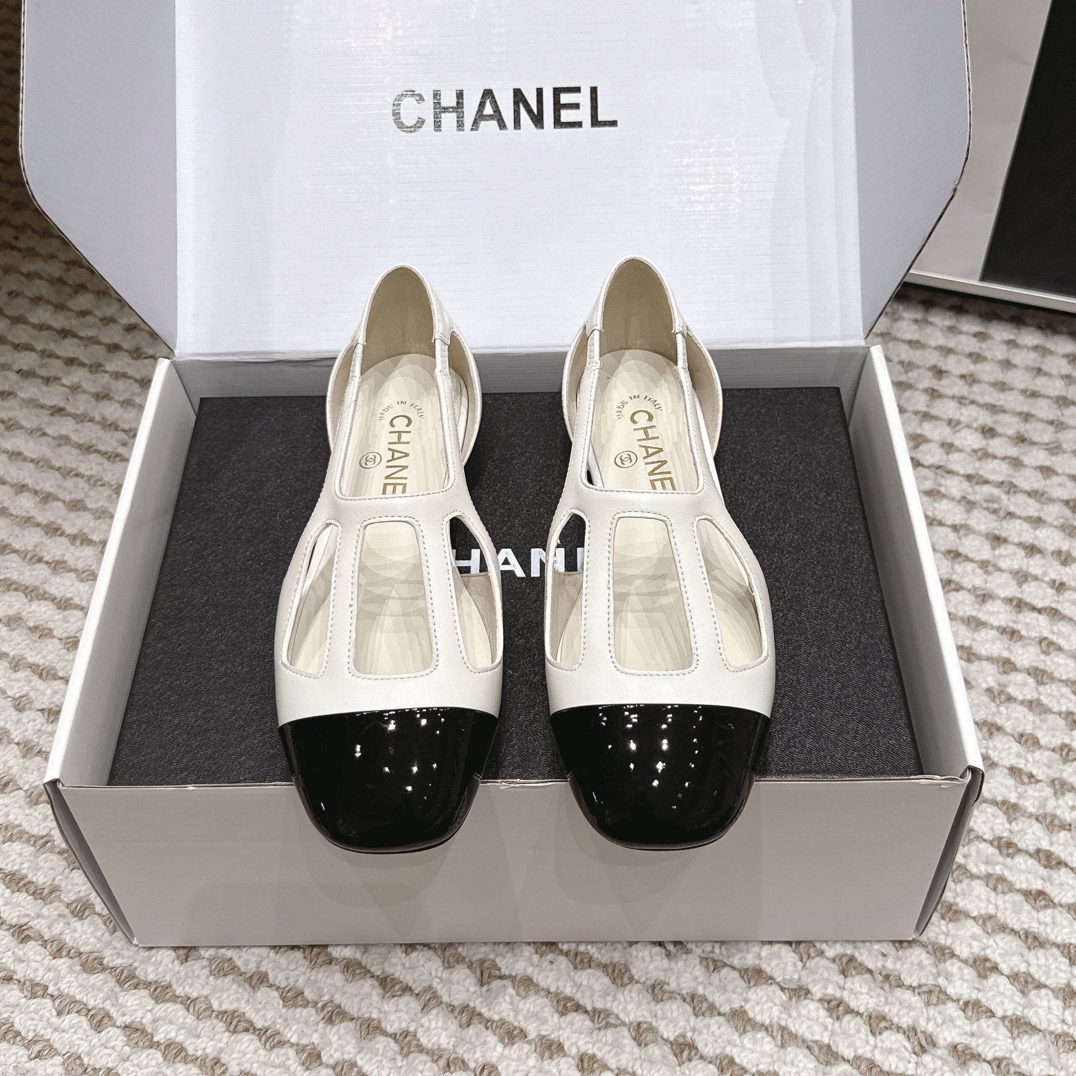 CHANEL 26S ROUND TOE MARY JANE FLATS IN OFF WHITE CUTOUT CALFSKIN WITH BLACK PATENT TOE