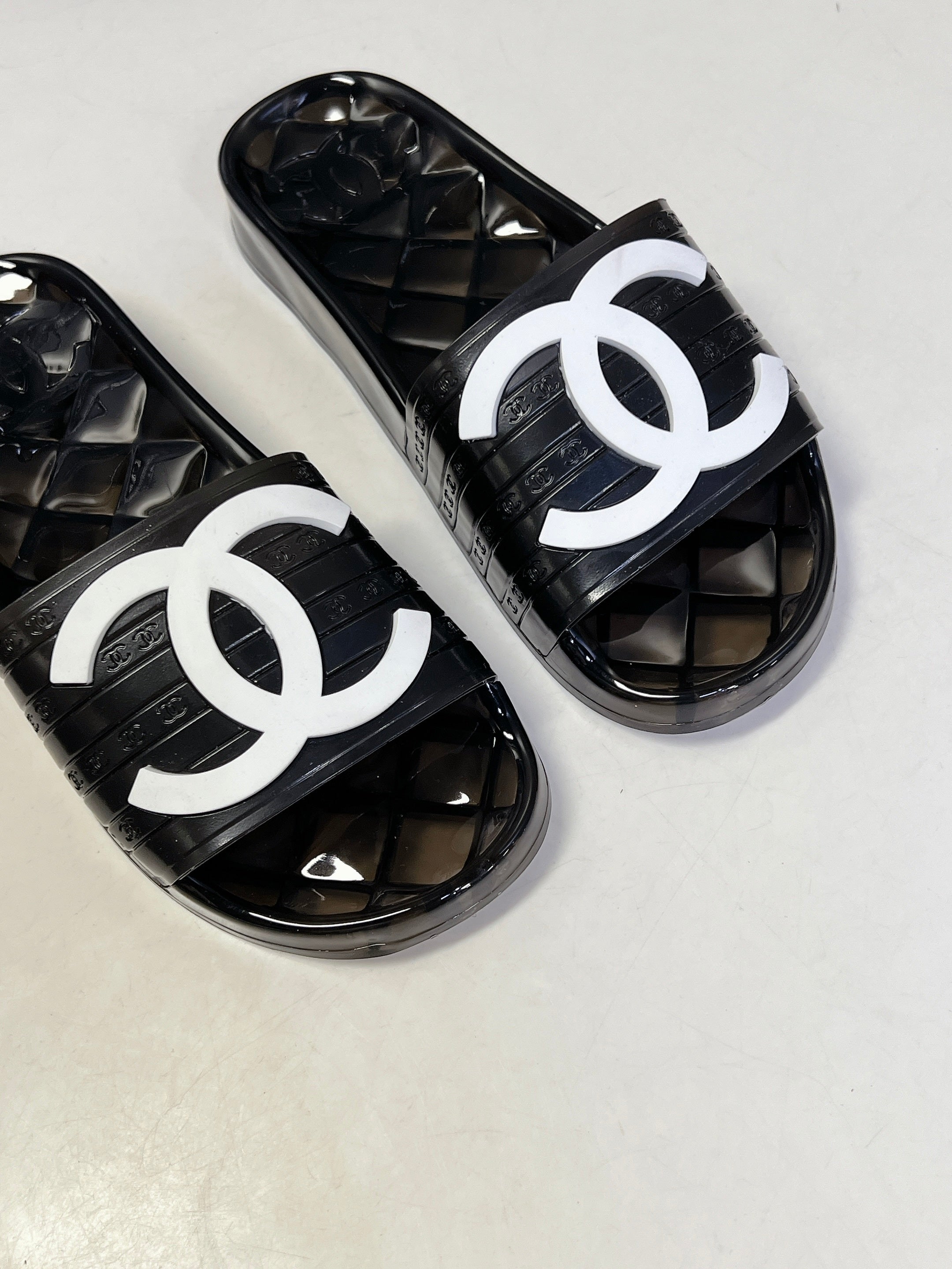 CHANEL 26S SLIDES IN BLACK PVC WITH WHITE LOGO