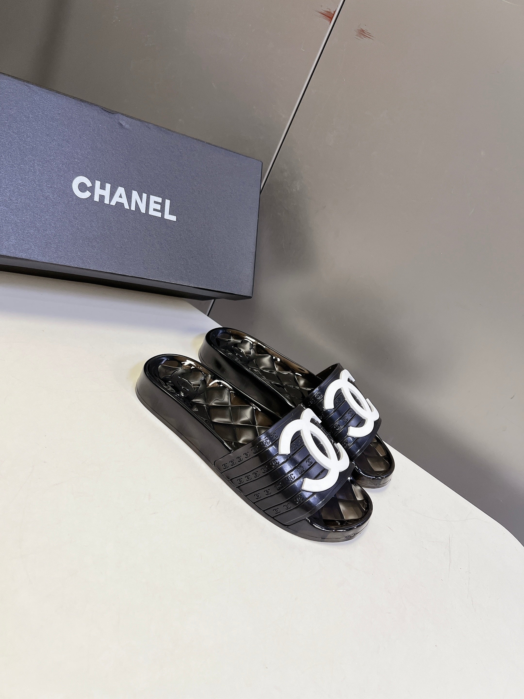 CHANEL 26S SLIDES IN BLACK PVC WITH WHITE LOGO
