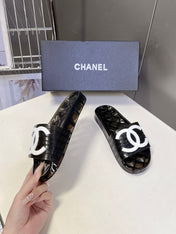 CHANEL 26S SLIDES IN BLACK PVC WITH WHITE LOGO