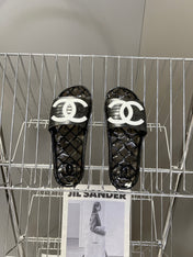 CHANEL 26S SLIDES IN BLACK PVC WITH WHITE LOGO