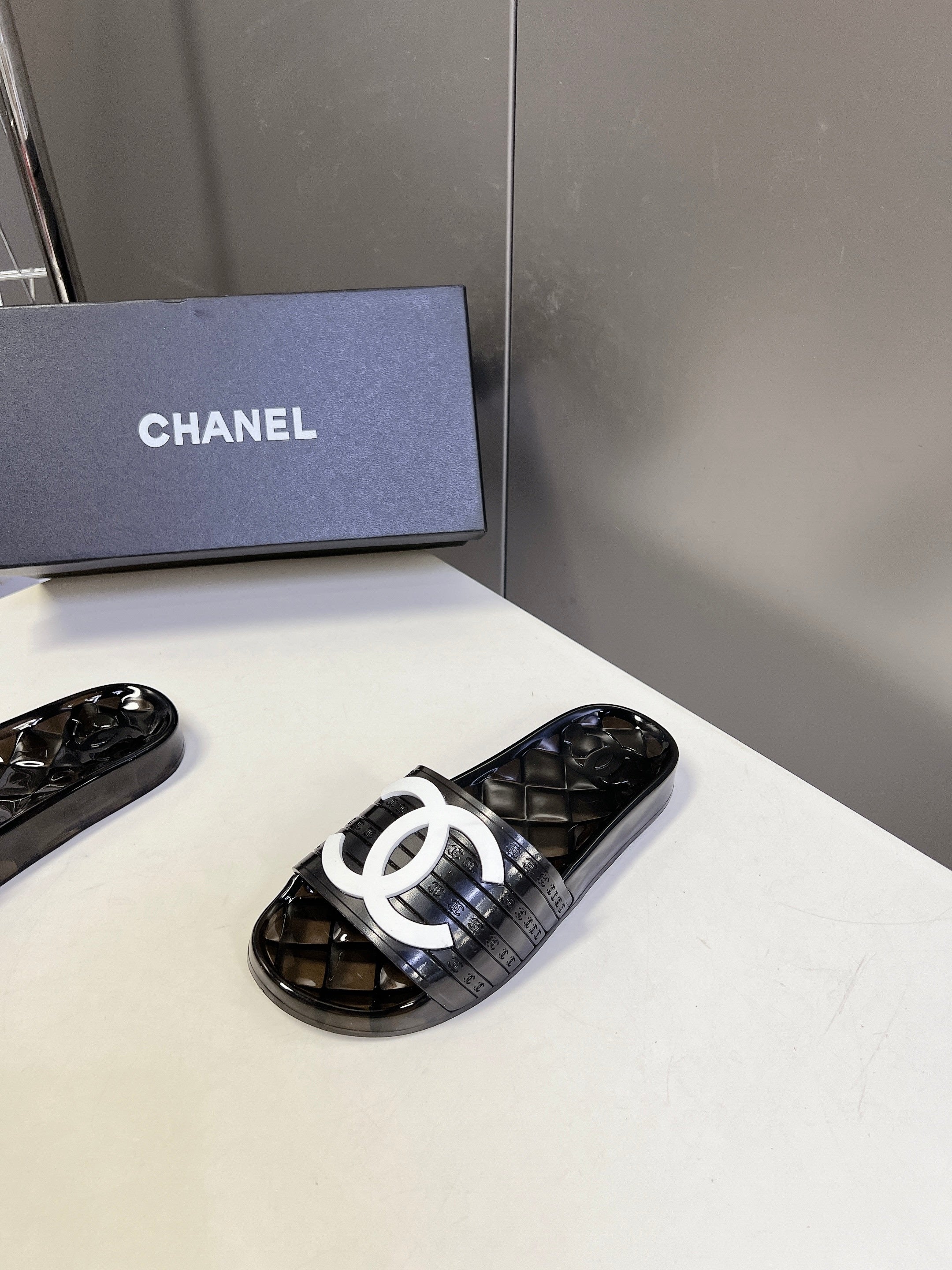CHANEL 26S SLIDES IN BLACK PVC WITH WHITE LOGO