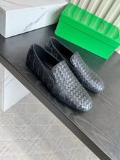 BOTTEGA VENETA 26S FLAT MULES IN BLACK WOVEN LAMBSKIN