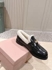 MIUMIU 25S PENNY LOAFERS 20MM IN BLACK PATENT CALFSKIN WITH SHEARLING