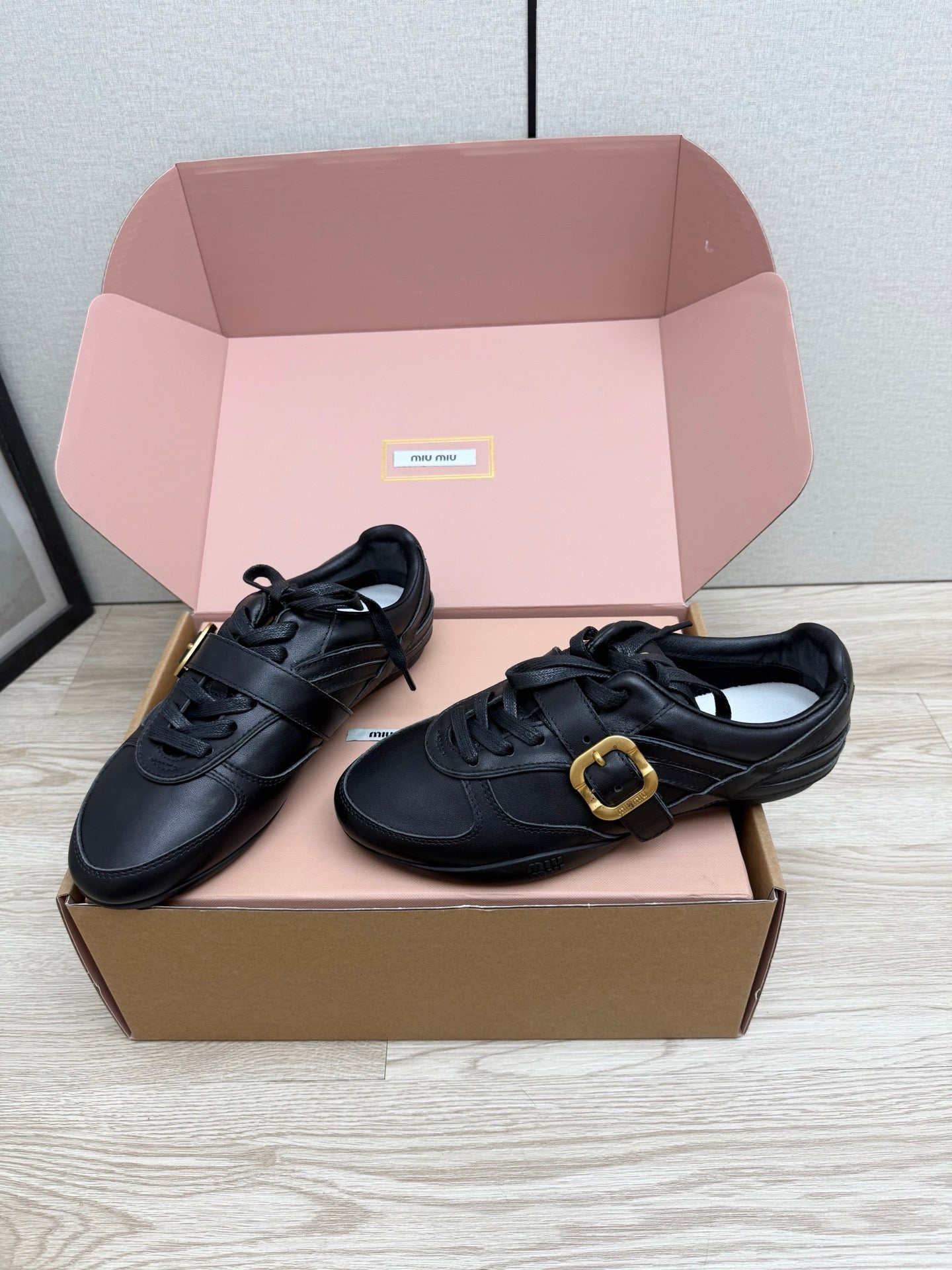 MIUMIU 26S BUCKLE SNEAKERS IN BLACK CALFSKIN WITH GOLD HARDWARE