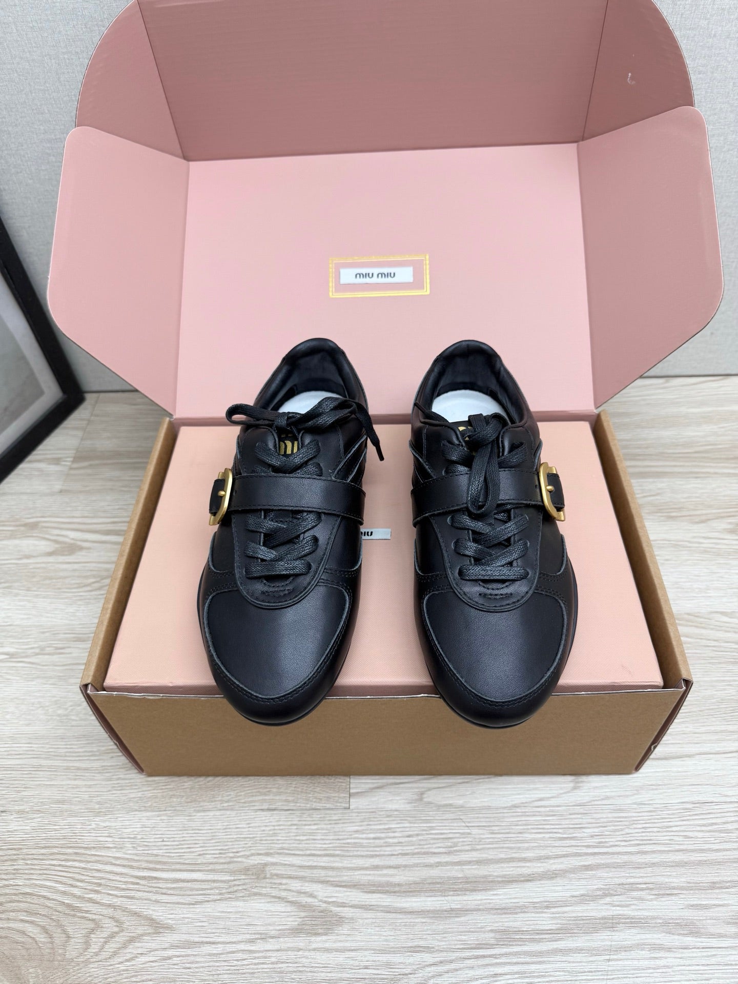 MIUMIU 26S BUCKLE SNEAKERS IN BLACK CALFSKIN WITH GOLD HARDWARE