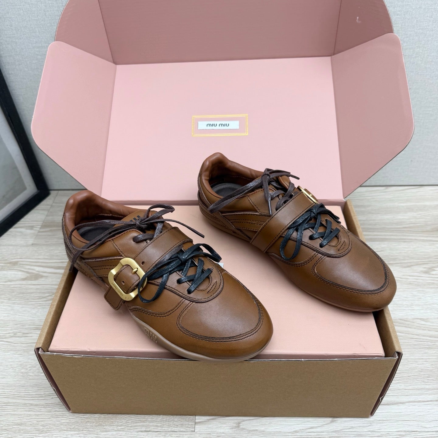 MIUMIU 26S BUCKLE SNEAKERS IN BROWN CALFSKIN WITH GOLD HARDWARE