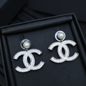 DOUBLE C EARRINGS IN SILVER METAL WITH BLACK SNOWFLAKE EMBOSSED ON WHITE ENAMEL
