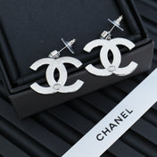 DOUBLE C EARRINGS IN SILVER METAL WITH BLACK SNOWFLAKE EMBOSSED ON WHITE ENAMEL