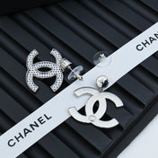 DOUBLE C EARRINGS IN SILVER METAL WITH BLACK SNOWFLAKE EMBOSSED ON WHITE ENAMEL